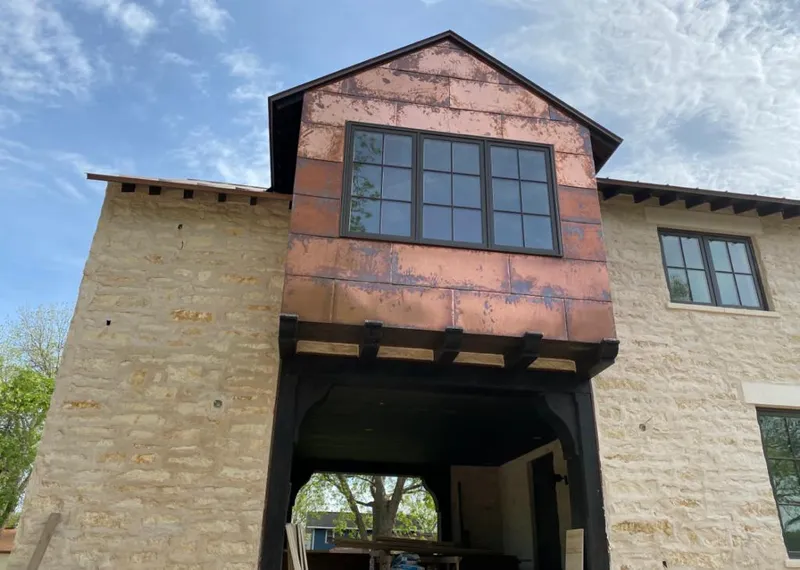 Copper metal panel facade on a stone building for Skylight Installation in Fleming Island