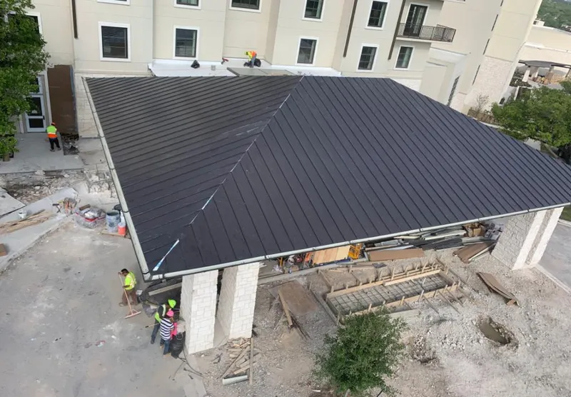 Metal roofing installation team working on a commercial building in Fleming Island